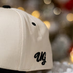 Beige cap with 'UG' logo on a blurred background