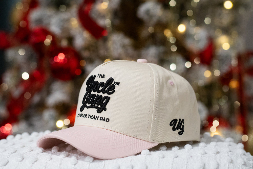 Beige cap with black text on a white surface with blurred festive background