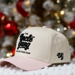 Beige cap with black text on a white surface with blurred festive background