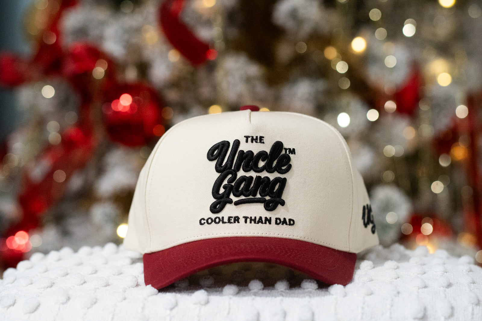 Cap with 'The Uncle Gang Cooler Than Dad' text against a festive background